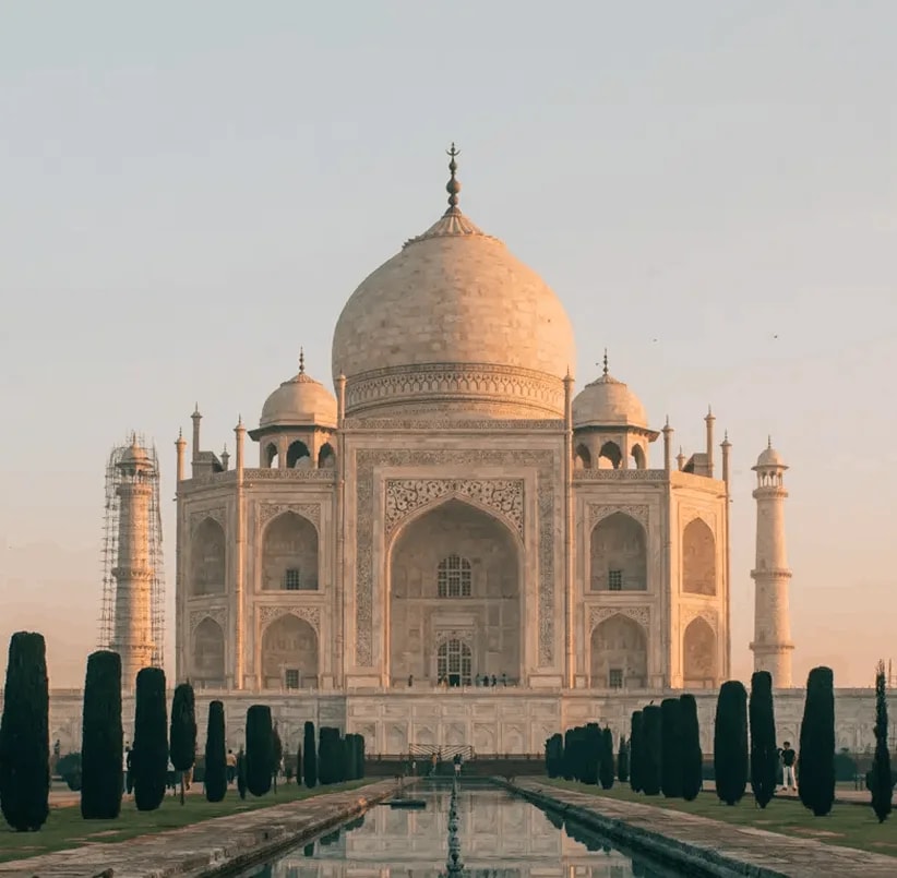 Taj Mahal at sunrise, reflecting pool and gardens — India